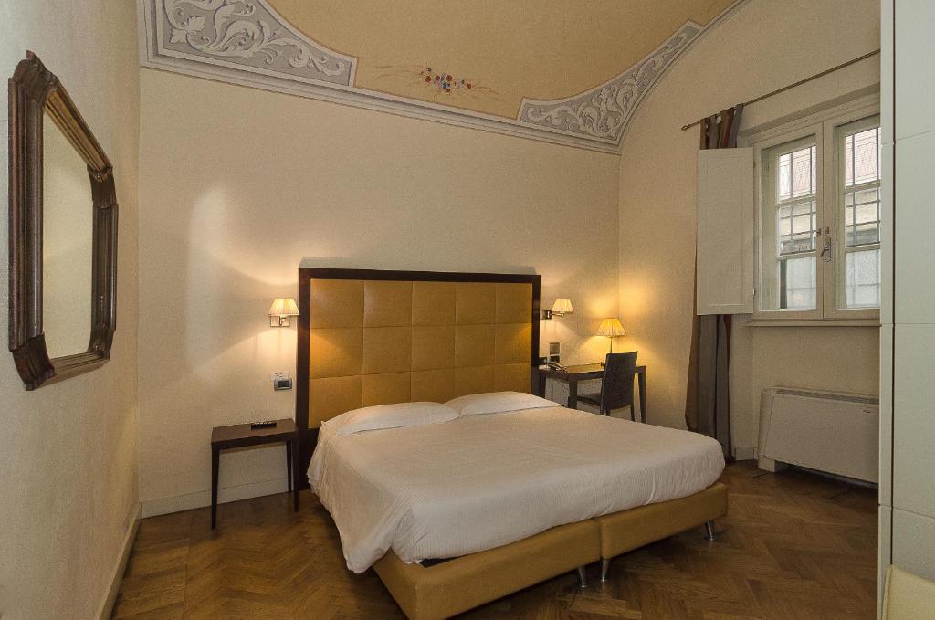 Postel nebo postele na pokoji v ubytování Hotel Novecento