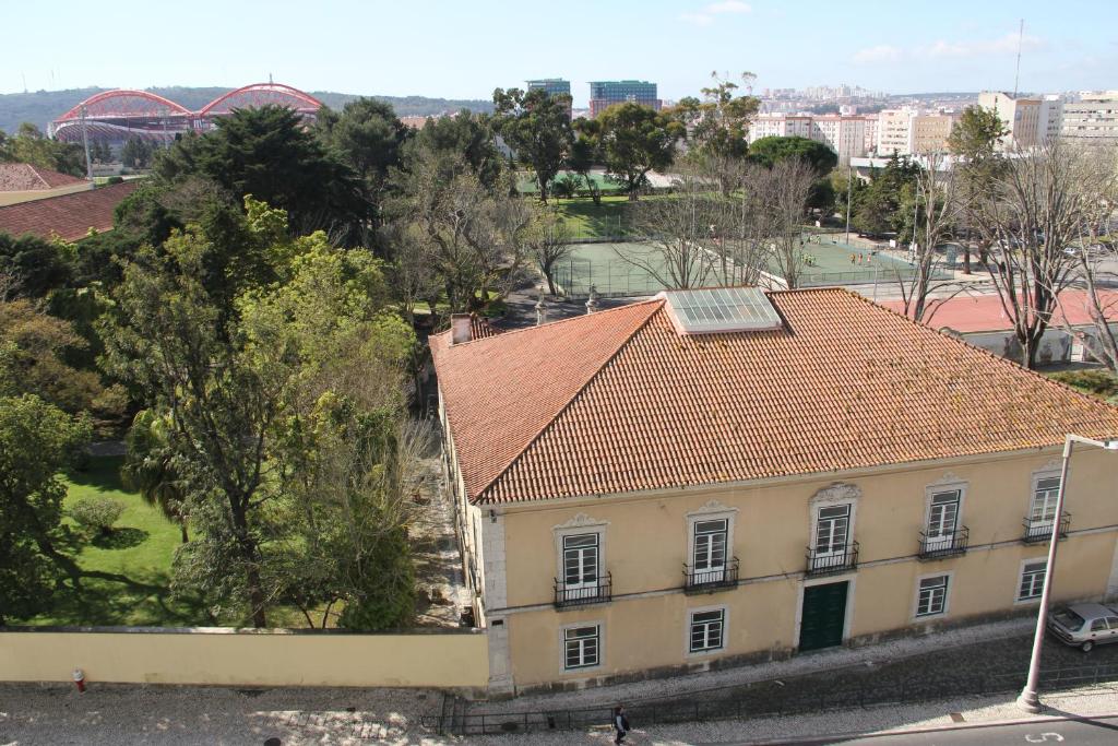a building with an orange tile roof in a city at Beautiful view close to Estádio da Luz in Lisbon