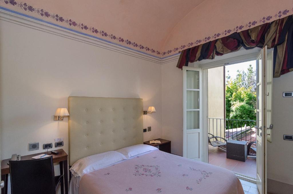 Postel nebo postele na pokoji v ubytování Hotel Novecento