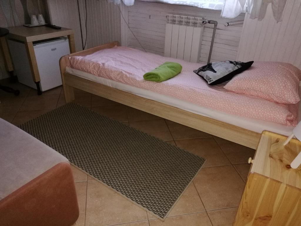 a room with two beds and a rug at Dom Mysliwski in Kobyłka