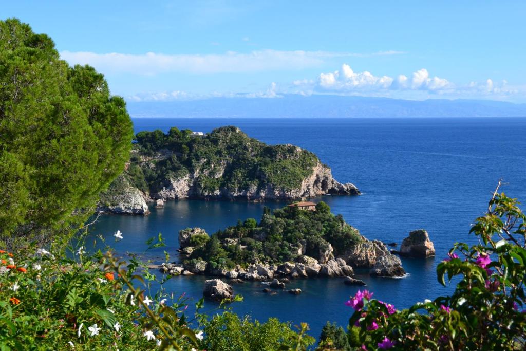 an island in the middle of the ocean at Charming Place Taormina in Taormina