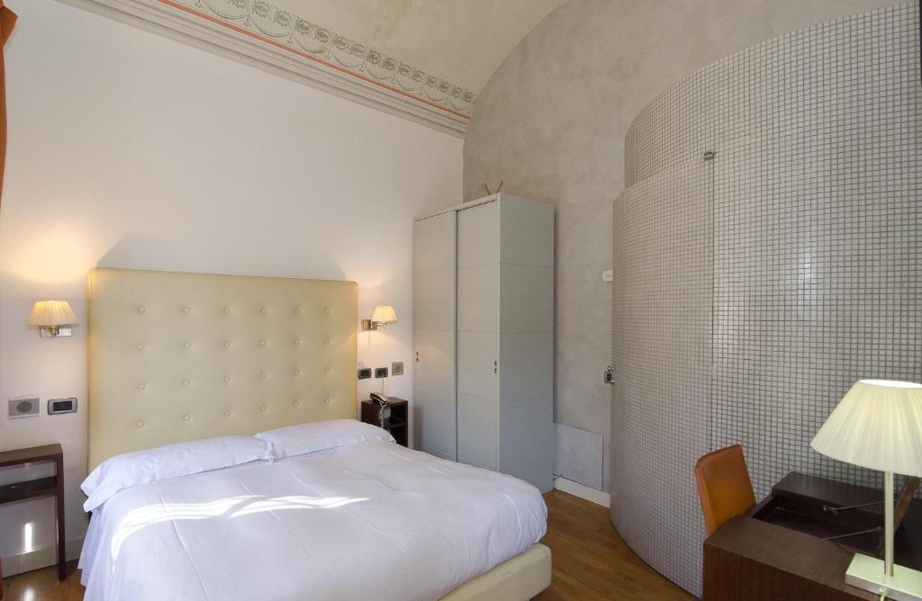 Postel nebo postele na pokoji v ubytování Hotel Novecento