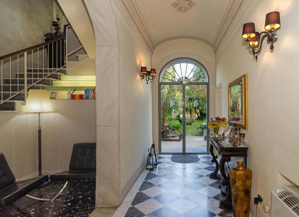 a hallway with a staircase and a entry way at Hotel Novecento in Pisa