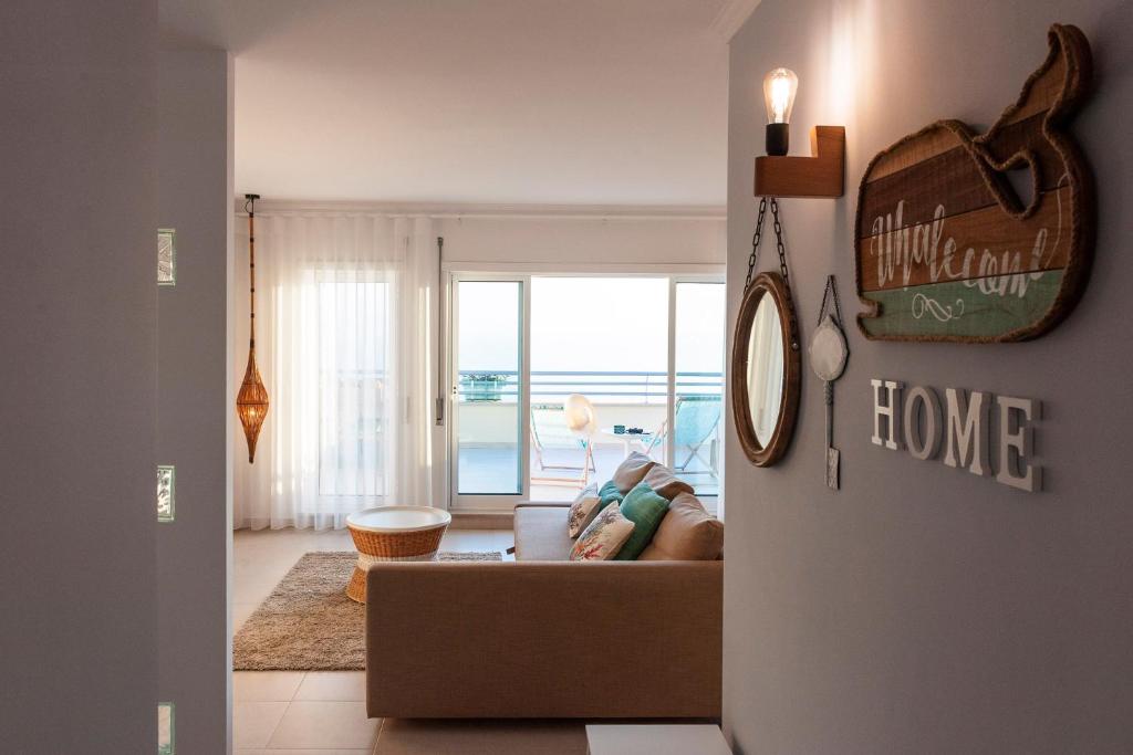 a person laying on a couch in a living room at Home Sweet Praia Penthouse in Nazaré