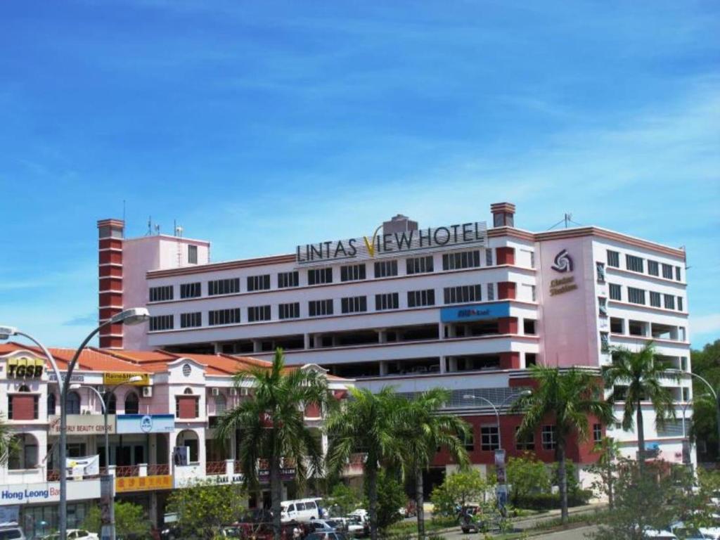a large white building with a sign on it at Lintas View Hotel in Kota Kinabalu