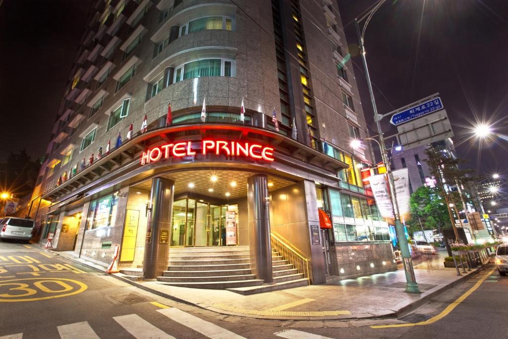 a hotel entrance on a city street at night at Hotel Prince Seoul in Seoul