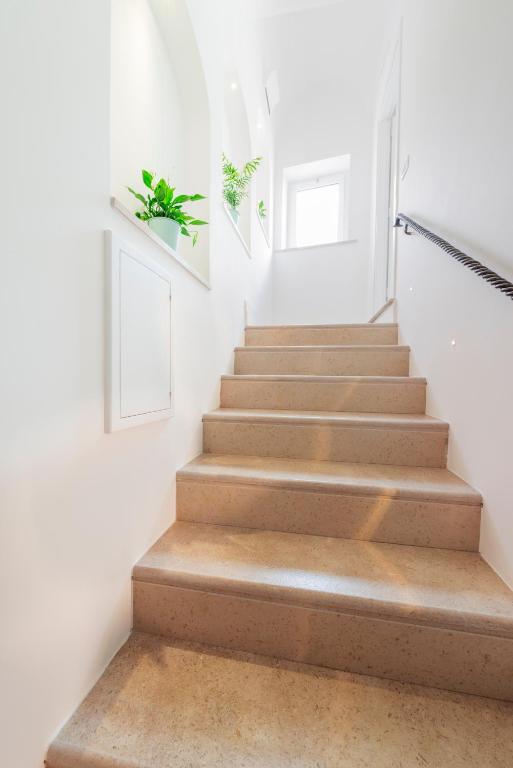 a staircase in a house with wooden steps at Casa Malu in Positano