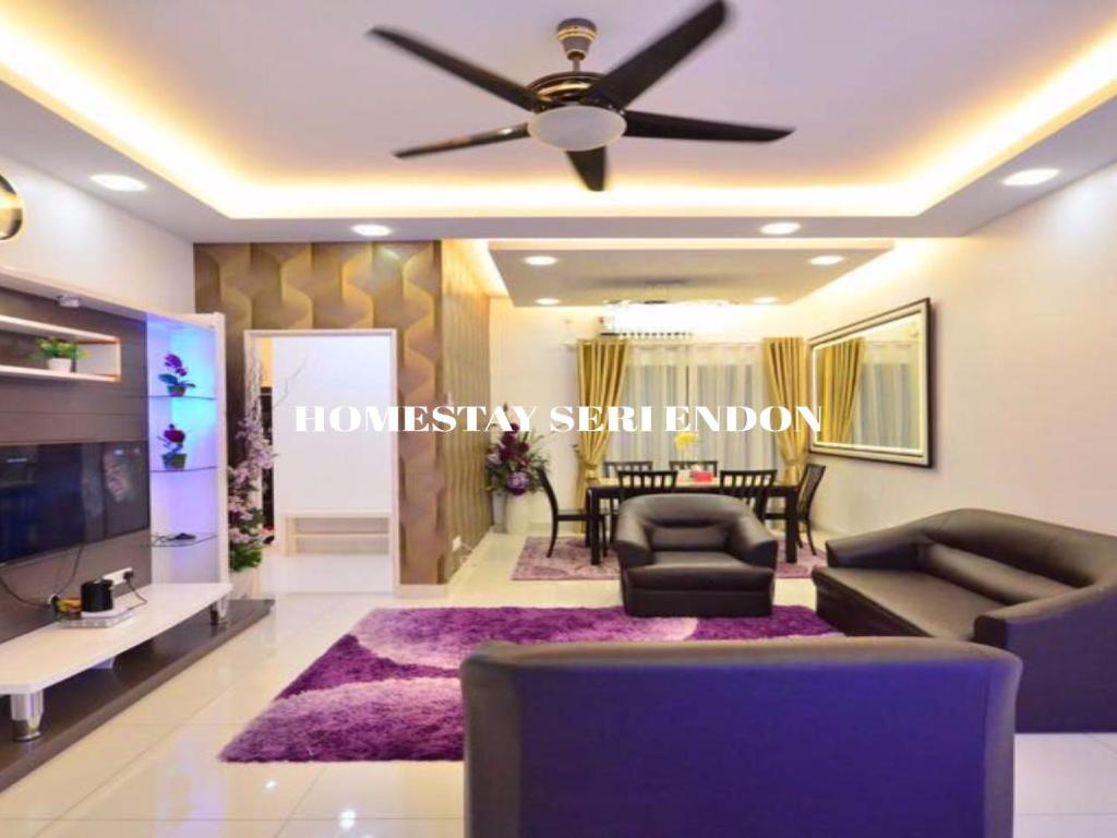 a living room with a ceiling fan and a purple rug at Seri Endon Apartment in Shah Alam