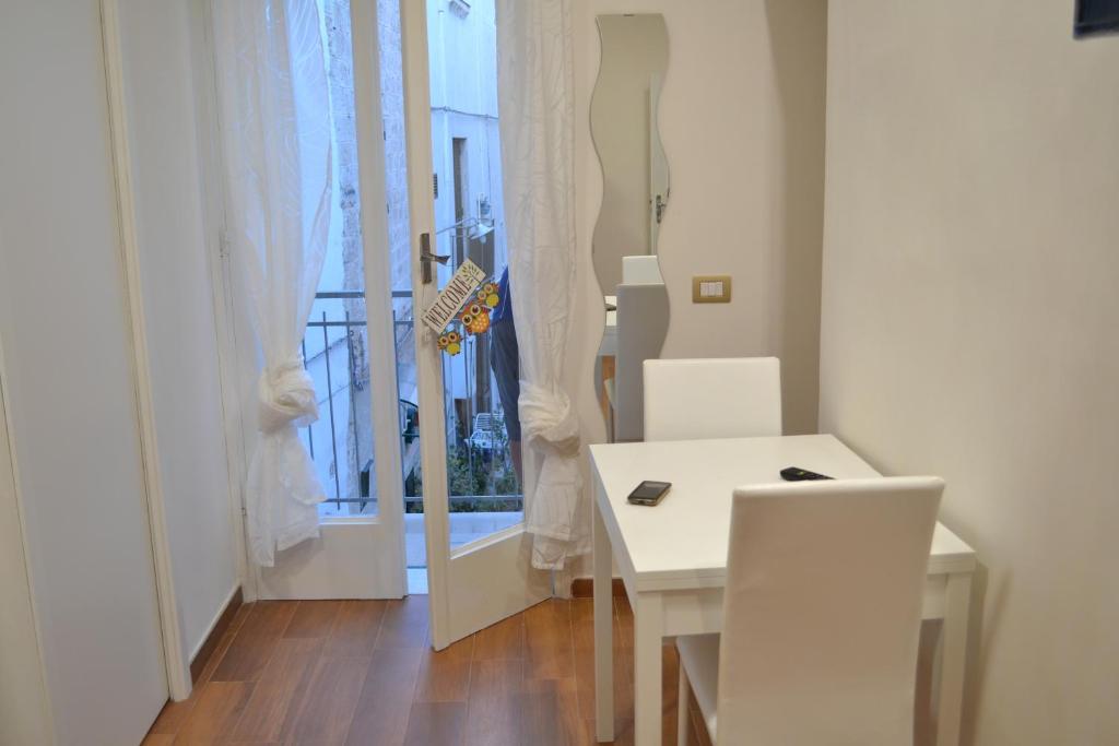 a white table and chairs in a room with a window at Il sogno di Ele in Polignano a Mare