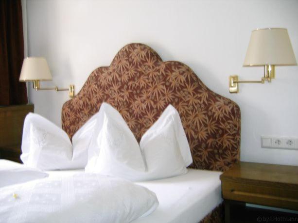 a bed in a hotel room with two pillows on it at Eintracht Hotel in Bad Wildbad