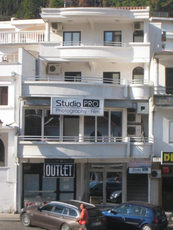 a building with cars parked in front of it at Apartments Circle Olive in Ulcinj
