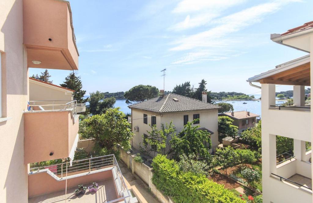 a view from the balcony of a house with a view of the water at Apartments Lara Pula in Pula