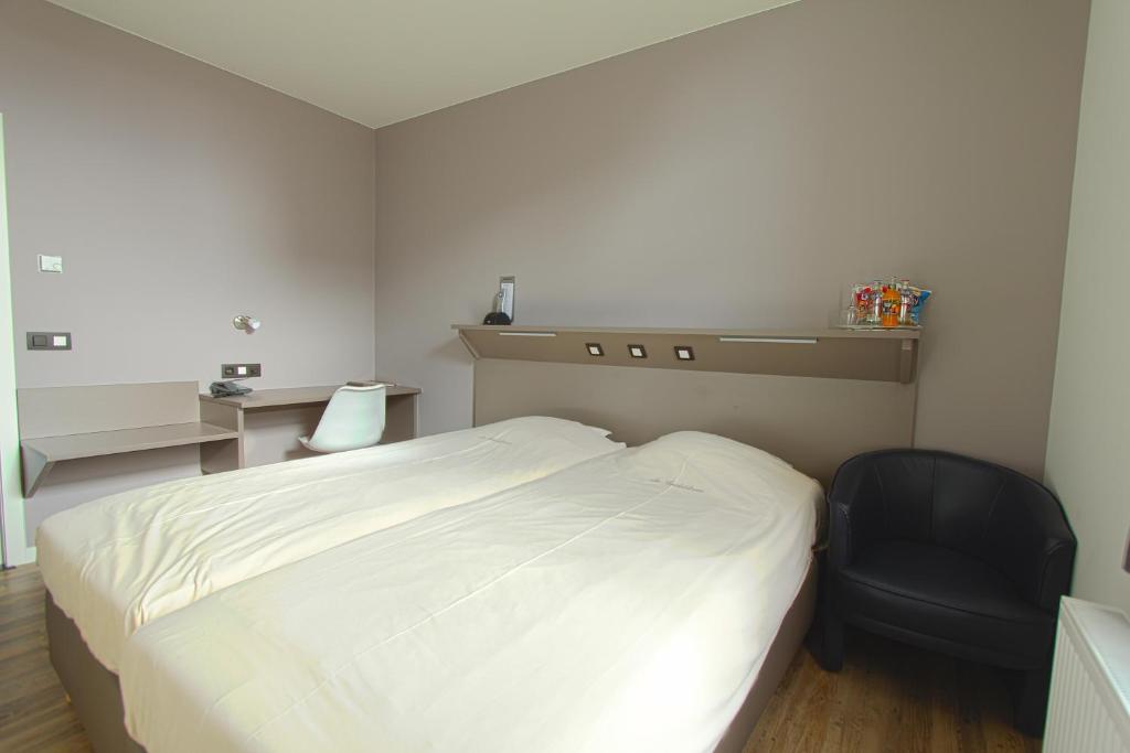 Ένα ή περισσότερα κρεβάτια σε δωμάτιο στο De Heidebloem