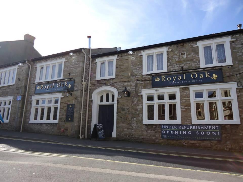 an old brick building on the side of a street at The Royal Oak in Settle