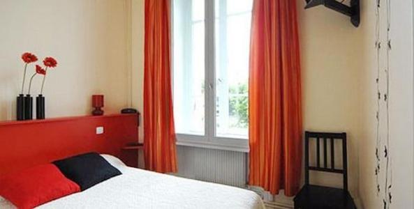 Postel nebo postele na pokoji v ubytování L'Hôtel L'Astrée