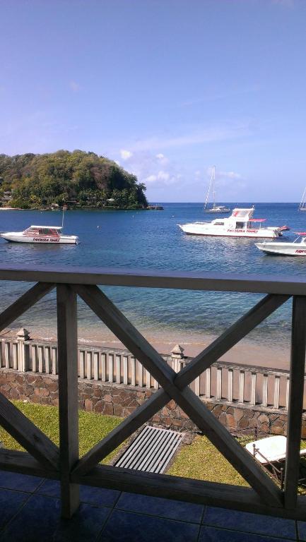 a view of the water with boats on the beach at Paradise Beach Hotel in Kingstown