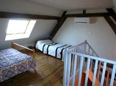 Postel nebo postele na pokoji v ubytování L'Ancien Presbytère