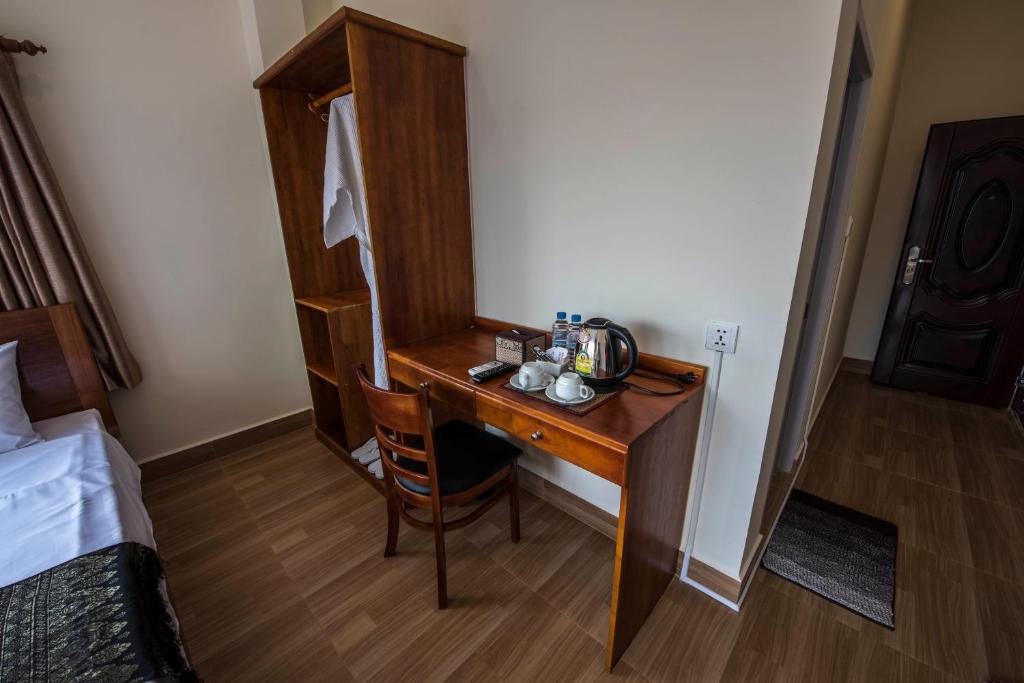 Postel nebo postele na pokoji v ubytování Phnom Penh Le Vincent Hotel