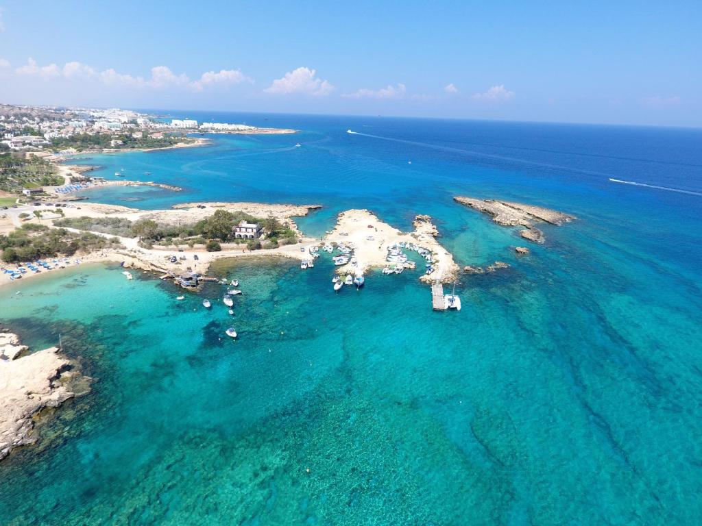 an aerial view of an island in the ocean at Thalassa Court Sandy Beach Apartment in Protaras