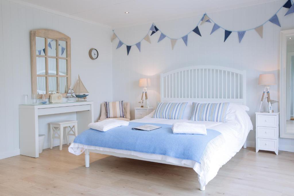 
a bedroom with a bed and a dresser at Sea View Snugs at Laggan in Gatehouse of Fleet
