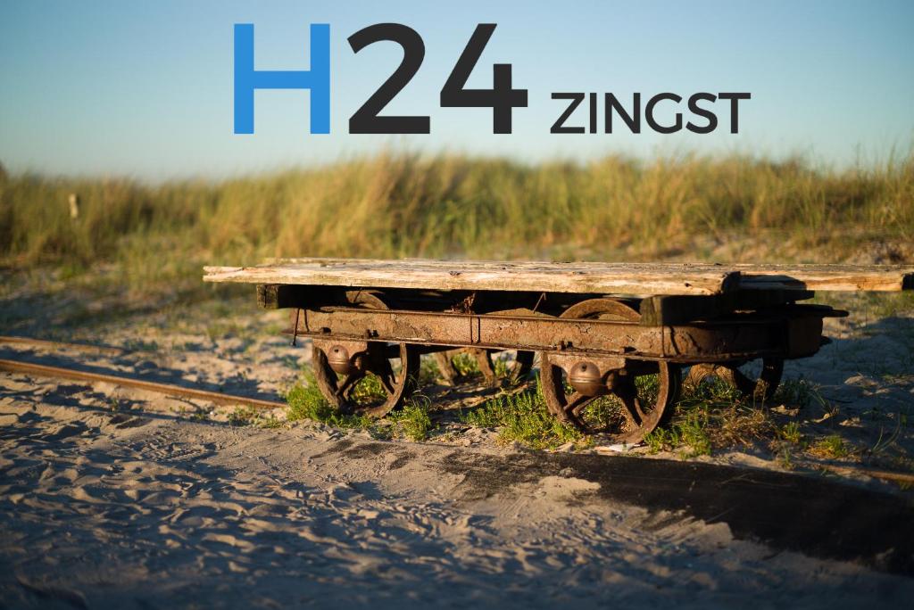 a picnic table sitting on the side of the tracks at H24ZINGST - Das Ferienhaus in Zingst