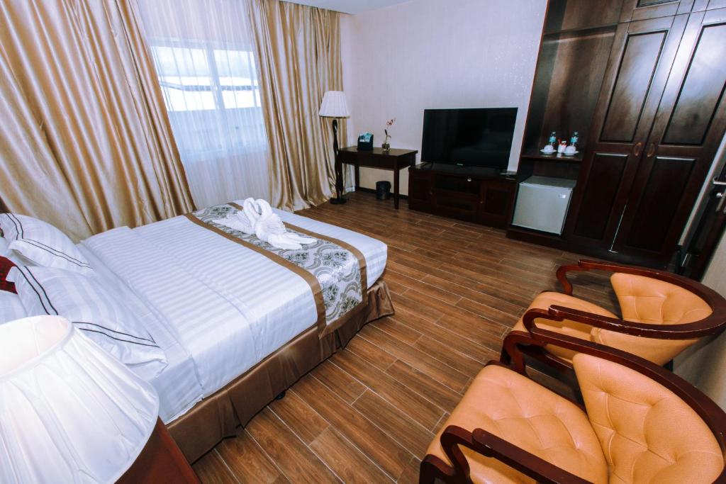 Postel nebo postele na pokoji v ubytování Palawan Uno Hotel