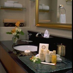 a bathroom with a sink and a counter top with a sink at Hotel Le Soleil by Executive Hotels in Vancouver