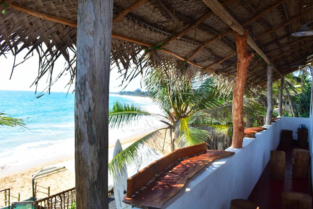a resort with a view of the beach and the ocean at Villa crocodile beach in Hikkaduwa