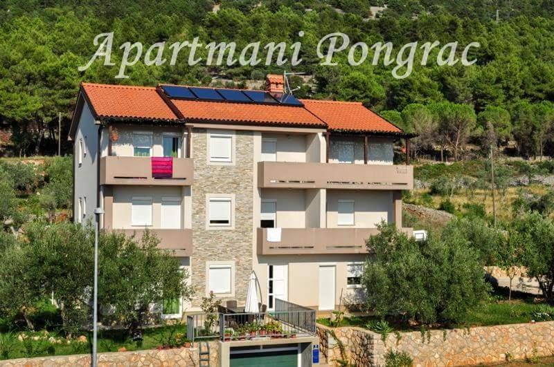 a building with a sign that reads apartments pomanca at Apartments Pongrac in Cres