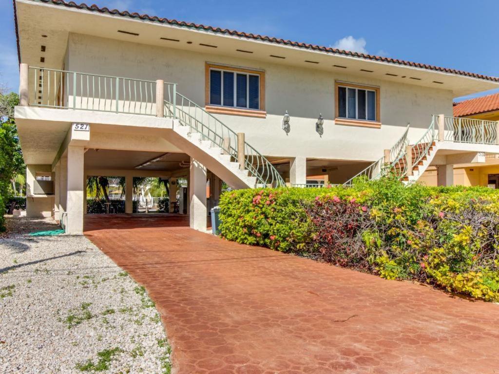 a house with a walkway in front of it at Breezy Palms in Key Colony Beach