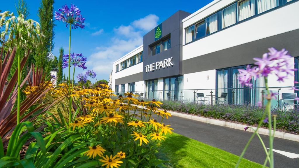 a flower garden in front of a large building at The Park Hotel in Barnstaple