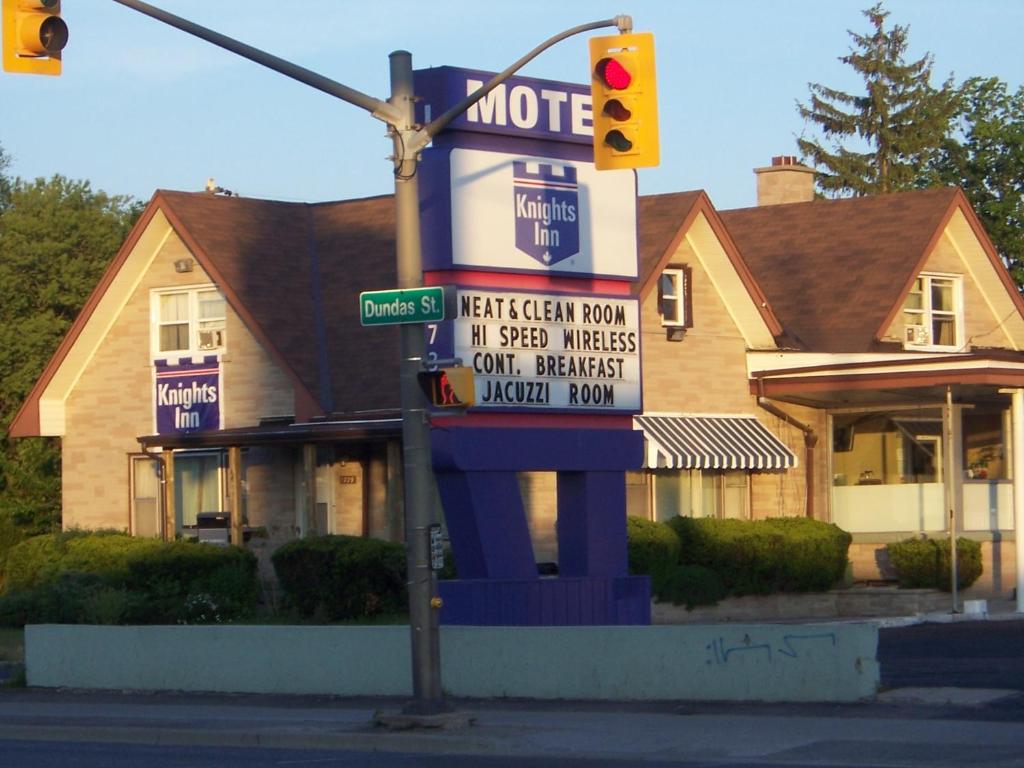 a traffic light in front of a house at Knights Inn London Ontario in London