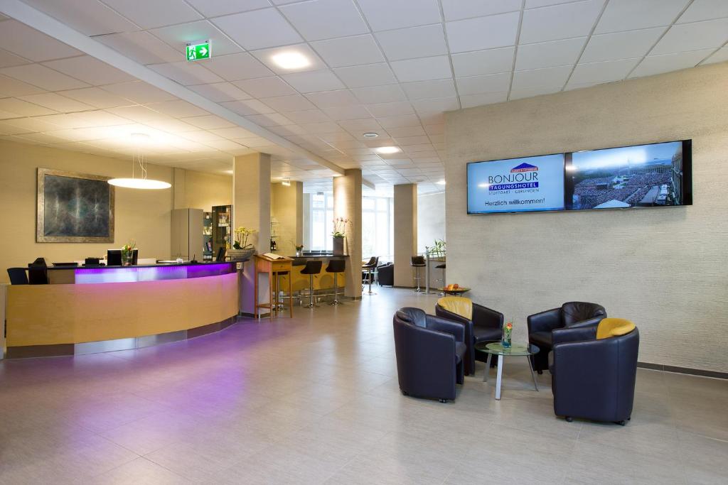 a hospital lobby with chairs and a tv on the wall at bonjour Tagungshotel Stuttgart-Gerlingen in Gerlingen