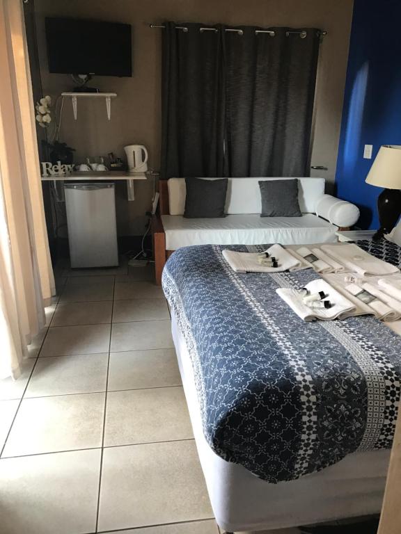 um quarto de hotel com duas camas e uma cozinha em De Charmoy Estate em Verulam