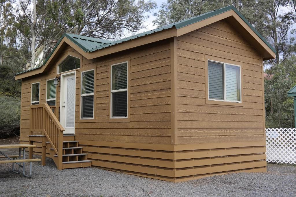 a tiny house with a porch and a deck at Pio Pico Camping Resort Cottage 1 in Jamul