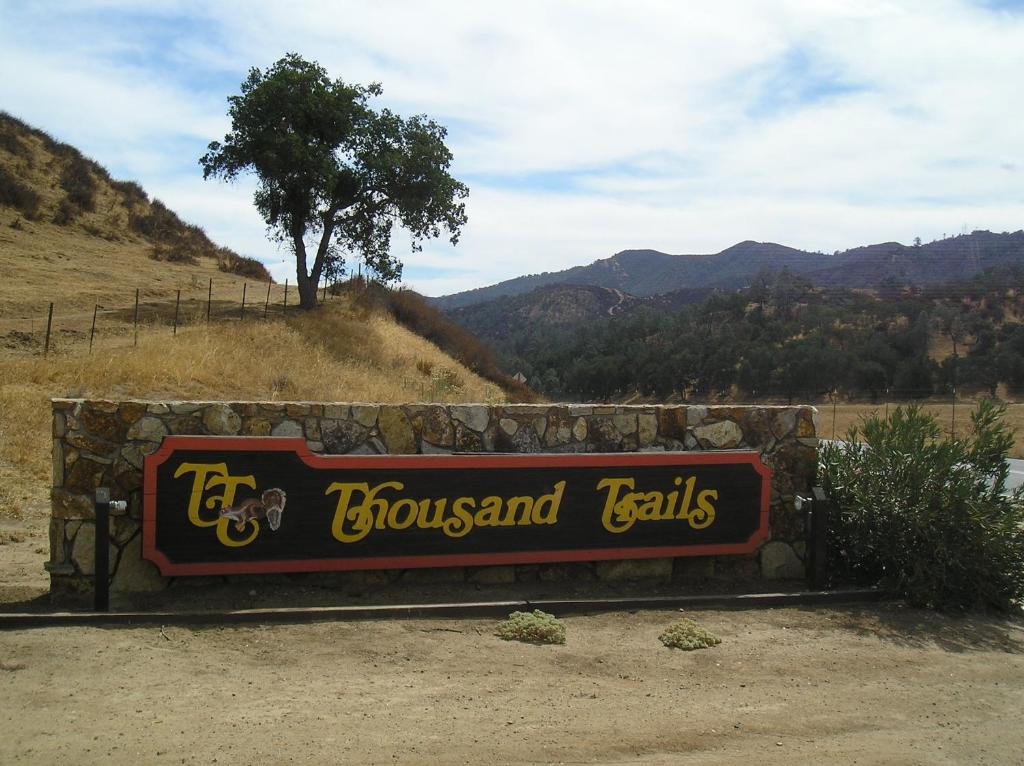 a sign for the crossroads of hills and trails at San Benito Camping Resort Cottage 10 in Paicines