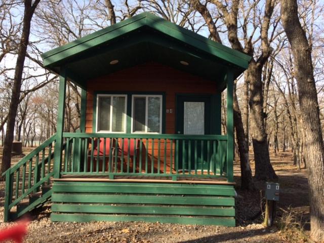 a small green house in the middle of trees at Pio Pico Camping Resort Studio Cabin 7 in Jamul