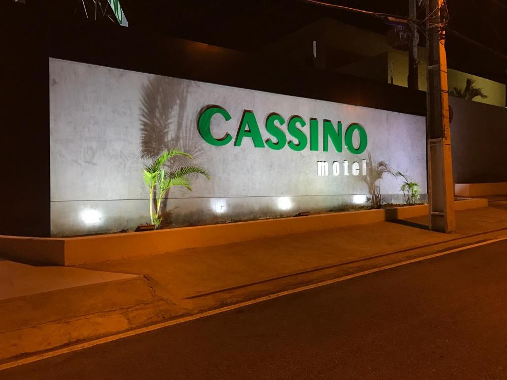 a sign for a casina hotel at night at Cassino Motel in Natal