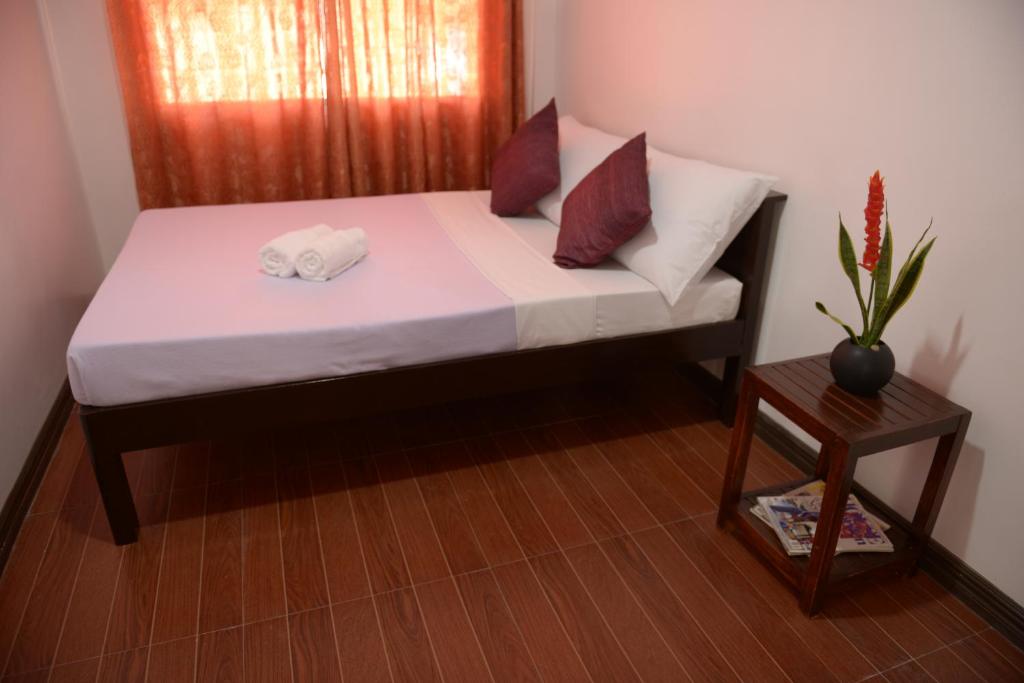 Postel nebo postele na pokoji v ubytování Globetrotter Inn - Palawan Inc.