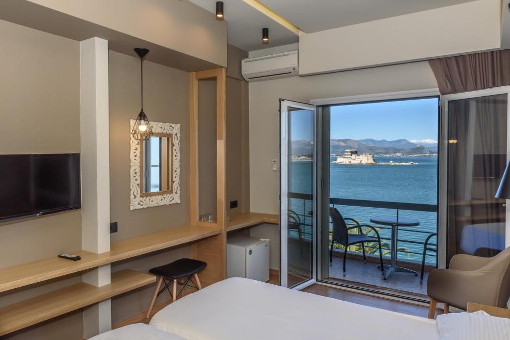 a hotel room with a view of the ocean at Agamemnon Hotel in Nafplio