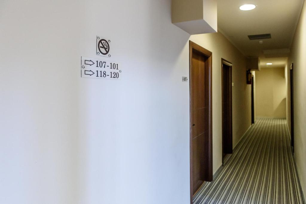 a hallway with a sign on the wall at Agamemnon Hotel in Nafplio