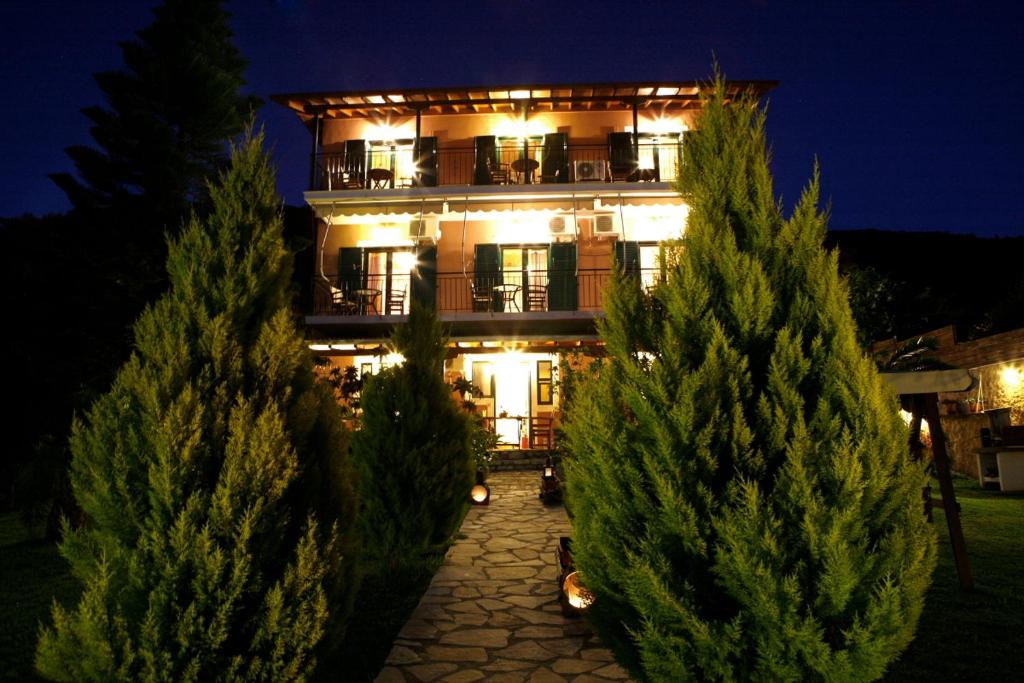 a lit up building with trees in front of it at George Studios in Yenion