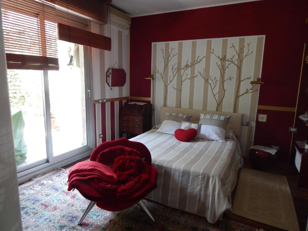 a bedroom with a bed with a red blanket on it at Forte House in Milan