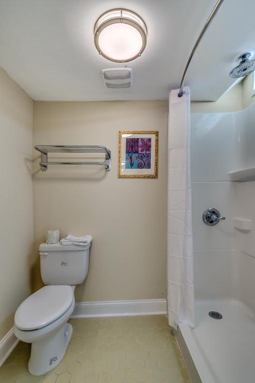 a bathroom with a toilet and a shower at Beachcomber Inn & Suites in Myrtle Beach