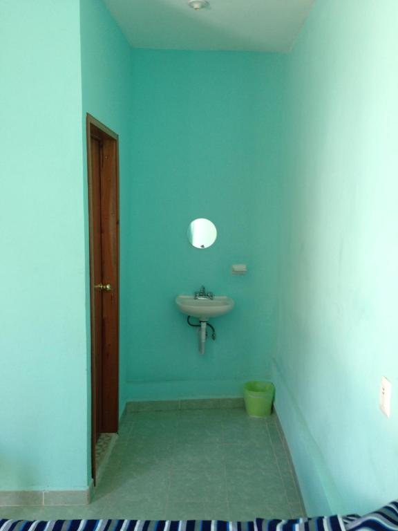 a bathroom with a sink and a mirror and a toilet at Hotel Chaac Calakmul in Xpujil