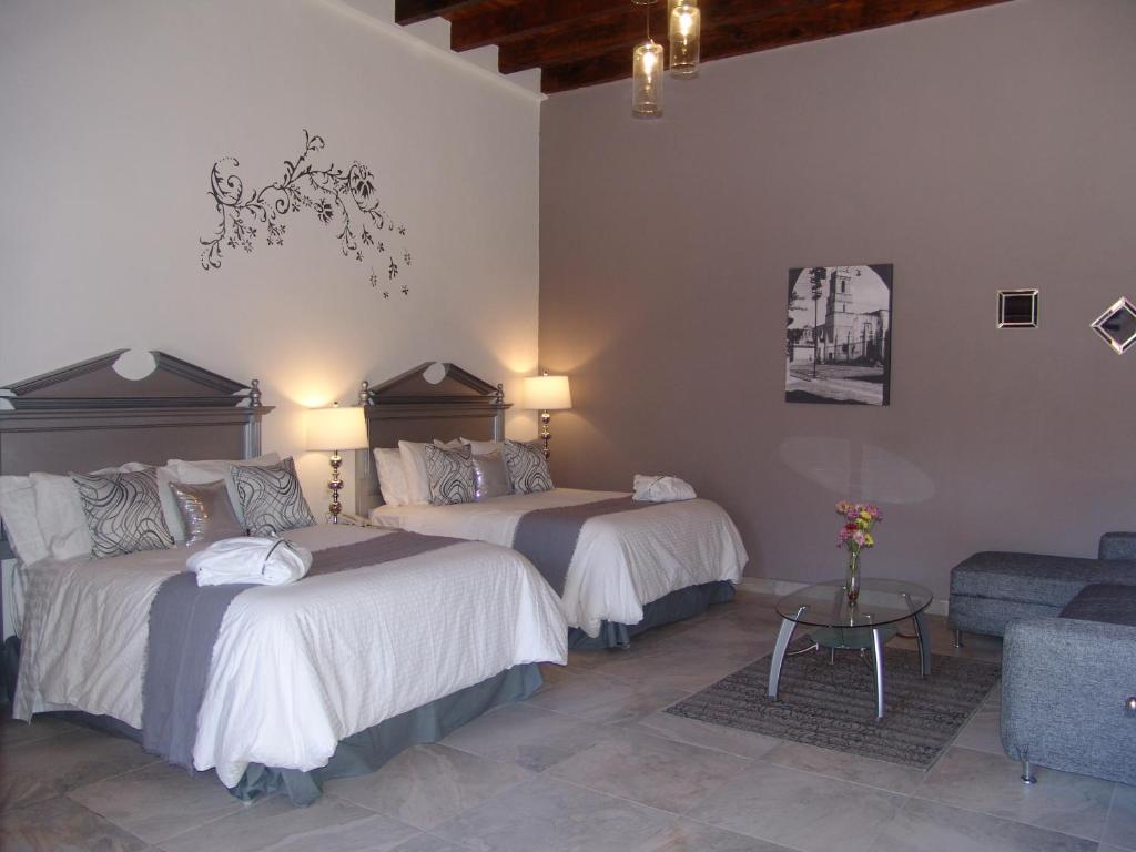 Postel nebo postele na pokoji v ubytování Hotel Casa Don Quijote