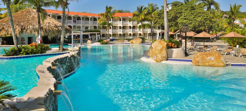 a swimming pool in a resort with blue water at Lifestyle Tropical Beach Resort & Spa All Inclusive in San Felipe de Puerto Plata