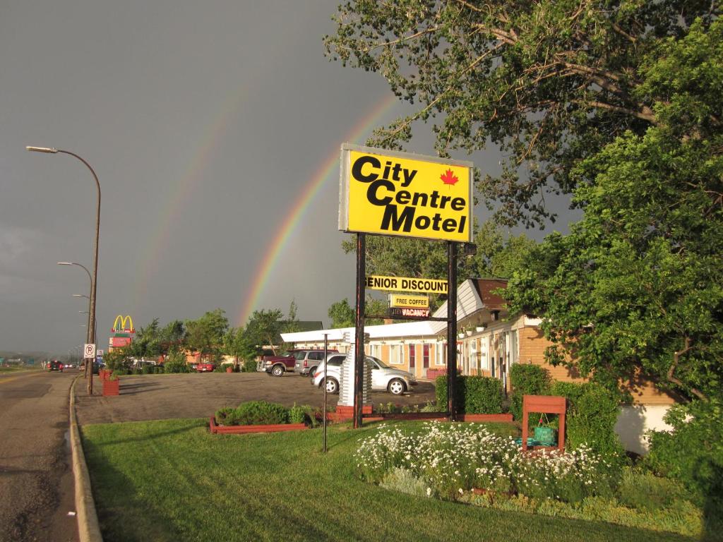 a city center motel with a rainbow in the sky at City Centre Motel in Swift Current