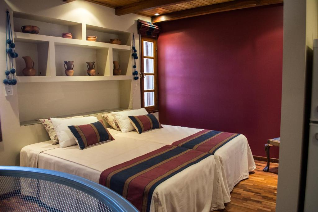2 camas en una habitación con una pared púrpura en Catalina Apart en San Salvador de Jujuy