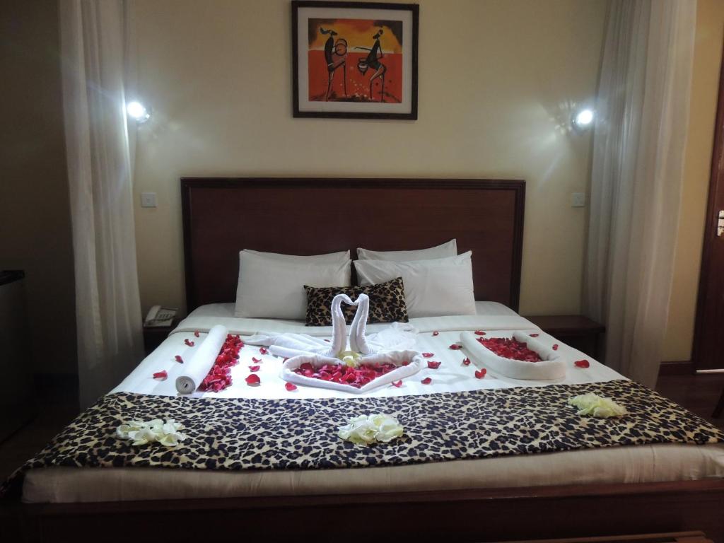 a bed with a swan and flowers on it at Hennessis Hotel in Nairobi